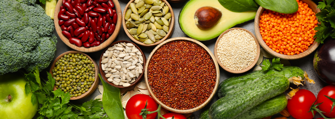 Top down view of table with a variety of vegetables and nuts scattered next to each other