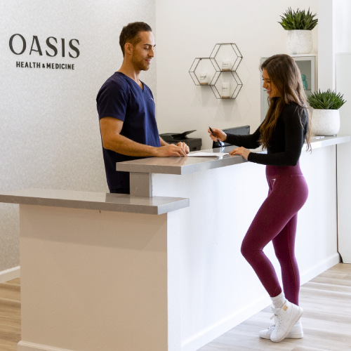Dr. Pedi Mirdamadi with a patient at the front counter of his clinic