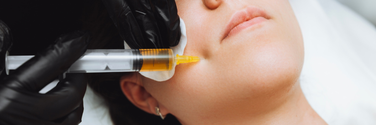 Woman receiving a PPR facial needle to her cheek