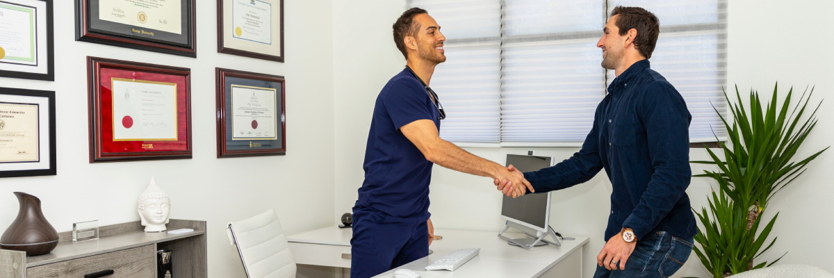 Dr. Pedi meeting with a patient in his clinic's office