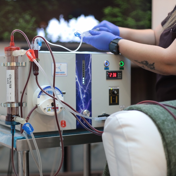 Healthcare practitioner setting up EBOO therapy machine
